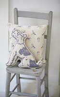 Patterned cushions on painted chair