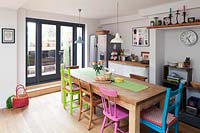 Painted chairs around kitchen table