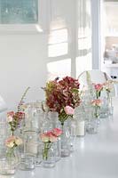 Floral display with Roses and Hydrangeas on white dining table
