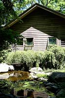 Timber house and garden with pond