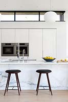 Marble kitchen counter with leather bar stools 