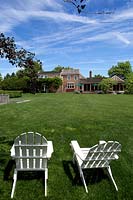White garden chairs on lawn