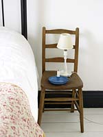 Wooden chair used as bedside table