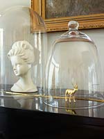 Gold reindeer ornament under glass dome