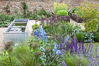 Colourful garden border with Allium Catmint and Delphinium flowers