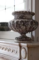 Vintage urn on marble mantlepiece