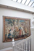Classic tapestry on staircase wall