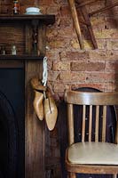 Vintage shoe lasts hanging from mantlepiece