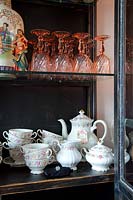 Patterned china displayed in cabinet