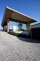 Cobbled drive and contemporary house