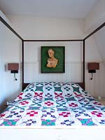 Four poster bed with patchwork quilt