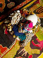 Tribal artefacts on patterned rug