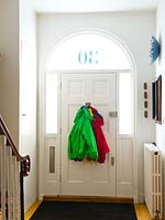 Coats hanging from back of door