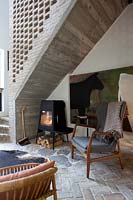Modern wood burning stove under stairs