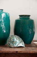 Green vases on vintage console table

