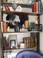 Eclectic ornaments and accessories on vintage shelving