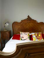 Vintage bed with pop art cushions