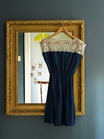 Dress hanging from vintage mirror