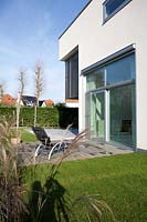 Contemporary house and garden with ornamental grasses
