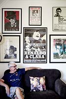 Man sitting with collection of music posters