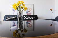 Vase of Daffodils on glass coffee table