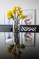 Vase of Daffodils on glass coffee table