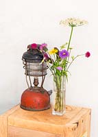 Vase of wildflowers and vintage lantern