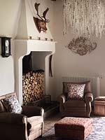 Brown armchairs by fireplace