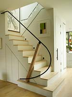 Open plan staircase with cupboards underneath