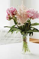 Vase of Astilbe and Peony flowers on kitchen table