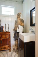 Oriental statue by bathroom sink