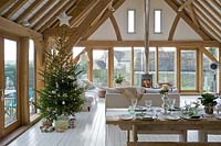 Open plan living and dining rooms decorated for christmas