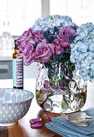 Vase of Roses and Hydrangea flowers on kitchen counter