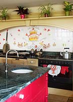 Red kitchen island with granite worktop
