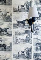Horse wallpaper and brass wall light