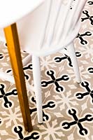 Patterned floor tiles under dining table