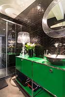 Metal sink on bright green vanity unit