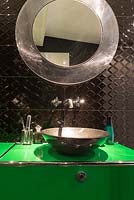 Metal sink on bright green vanity unit