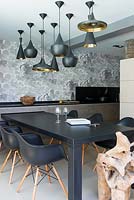 Metal pendant lights above dining table