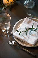 Olive foliage on white napkin