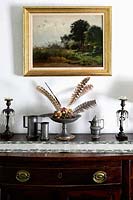 Pewter accessories on antique sideboard
