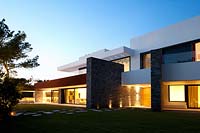 Contemporary house lit up at dusk