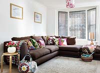 Brown corner sofa with patterned cushions