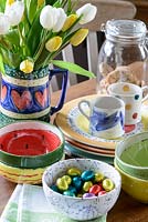Colourful crockery on kitchen table