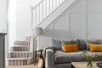 Grey sofa by stairs