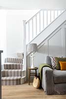 Grey sofa by stairs
