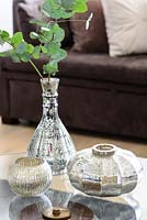 Silver accessories on glass coffee table