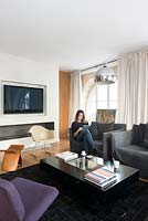 Woman sitting in modern living room