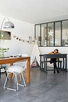 Child at desk in open plan dining room