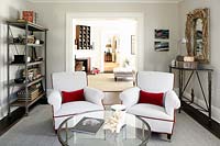 White armchairs with red cushions